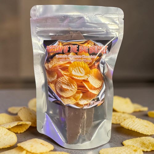 Bottom of The Bag Brickle bag on granite countertop surrounded by ruffled potato chips